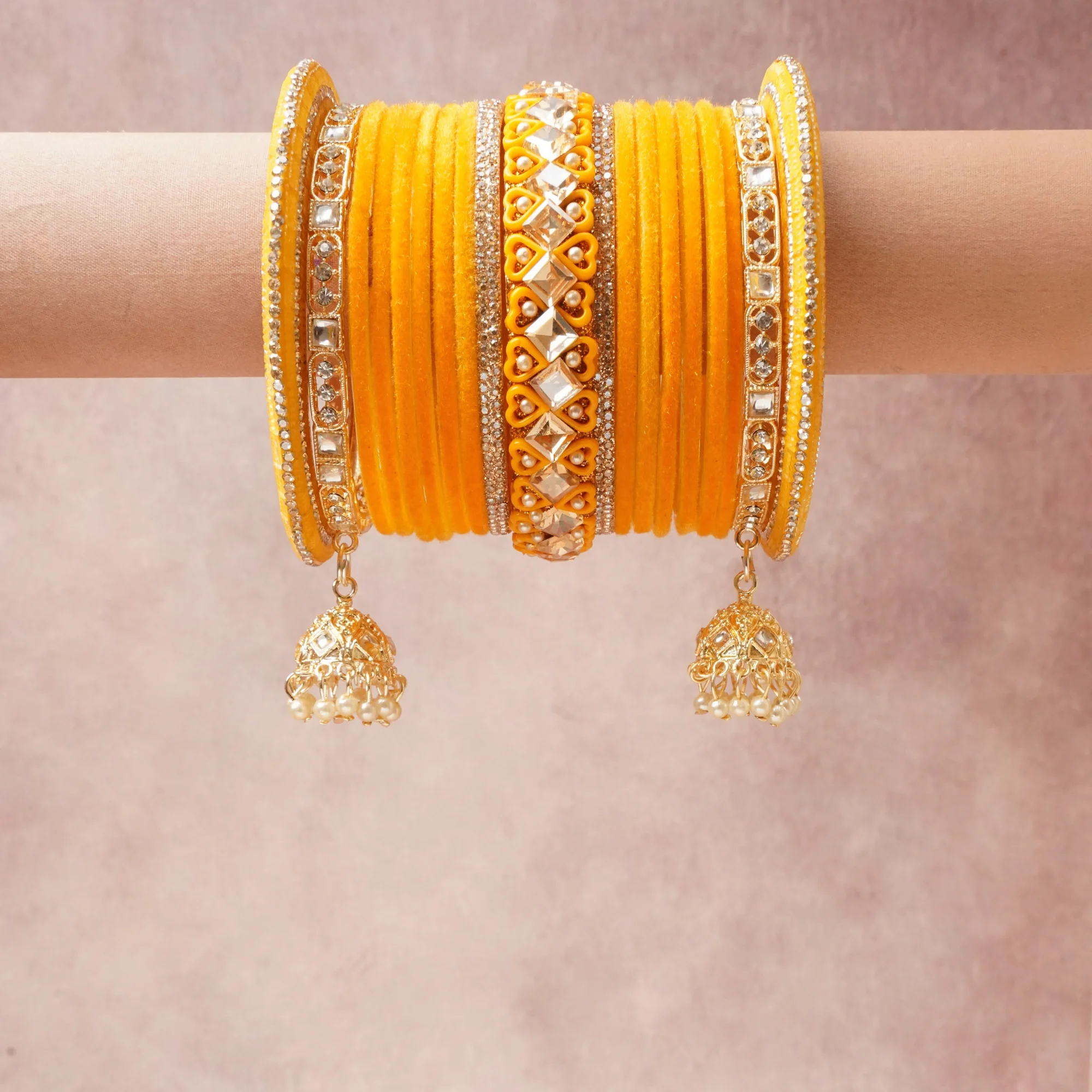 A commanding Saffron Yellow anchors this beautiful set, enriched with accents of Golden, Clear Crystal, Cream White that add depth and dimension.

Featuring a striking composition of Velvet Fabric, Gold-Plated Alloy, Cubic Zirconia, Polished Glass Inlay, Faux Pearls, this set carries intricate craftsmanship and strong presence. Grand in form, it is created for moments that deserve to be marked.